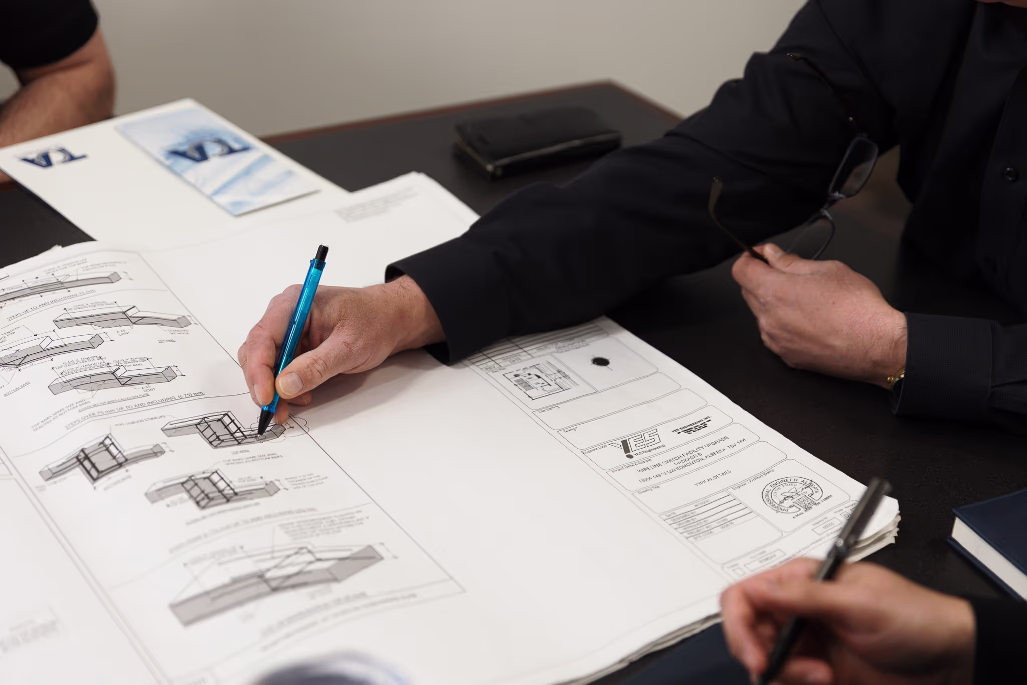 TCA team reviewing construction drawings during project planning