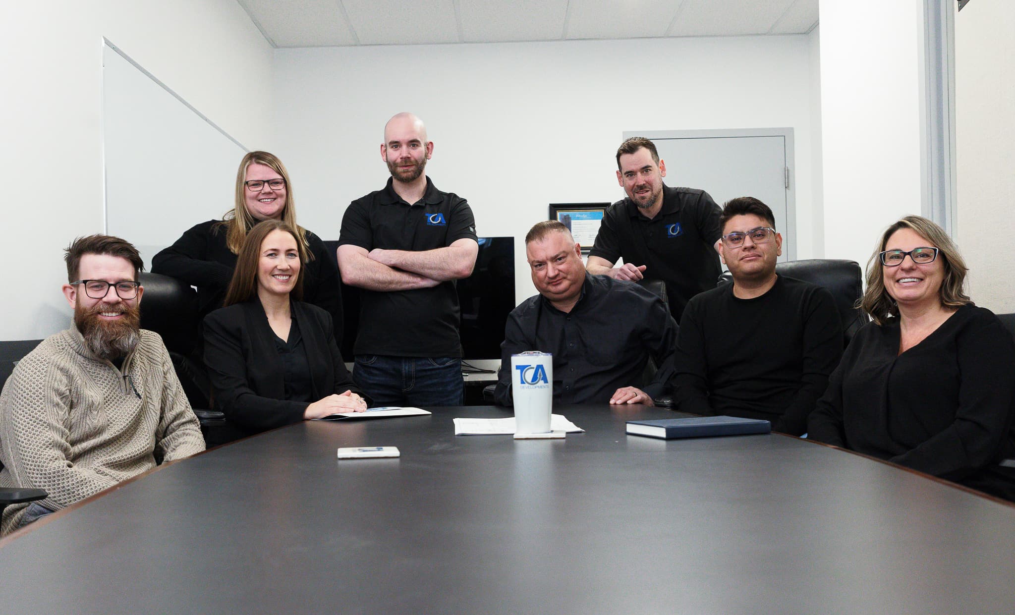 TCA project team gathered around a conference table